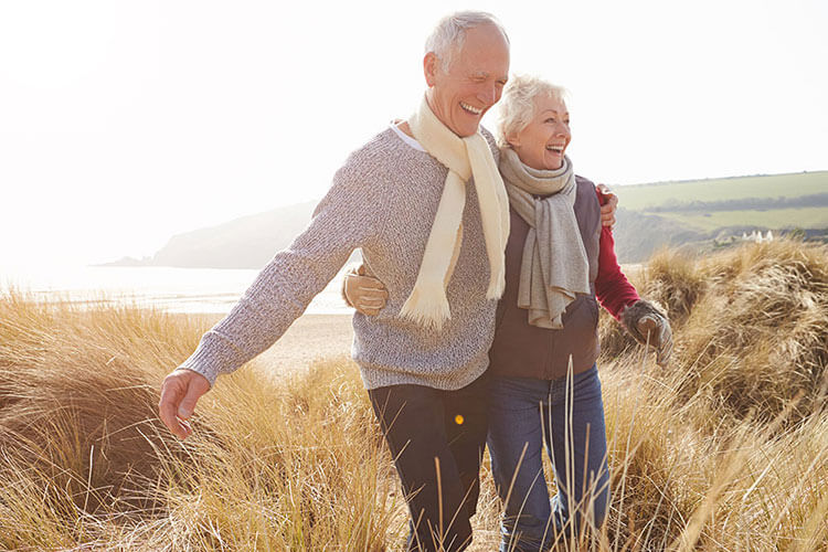 Older couple walking through the countryside