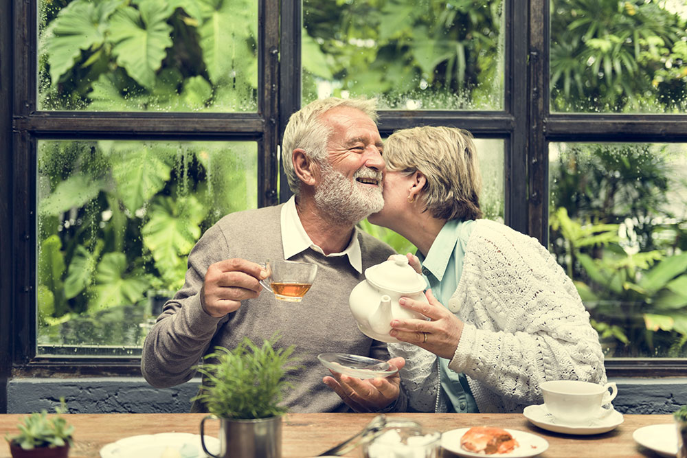 Older couple enjoying tea at a table