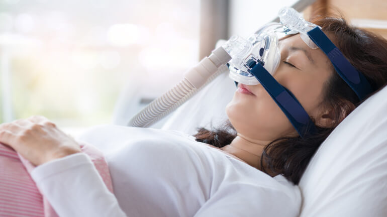 woman sleeping with a cpap mask on