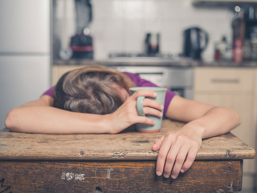 young woman passed out on kitchen table